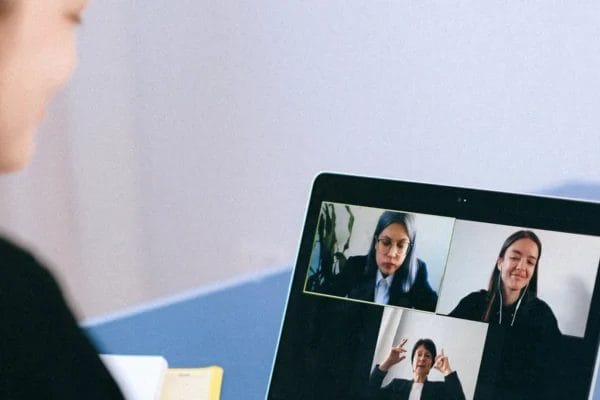 Woman participating in an online community meeting, representing safe moderated digital spaces